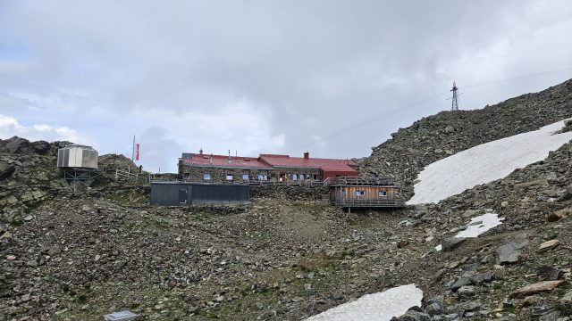 Glungezerhütte auf karger Hochgebirgskuppe mit umliegenden Felsen